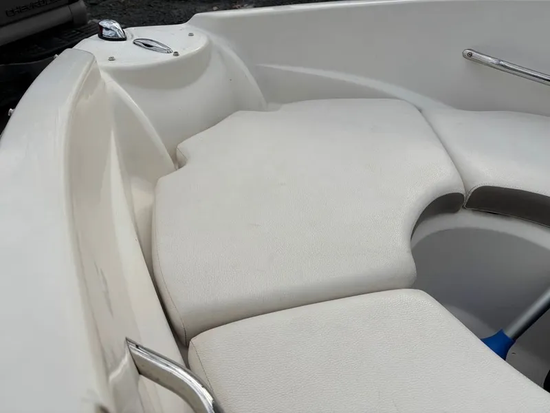 Slide: The Image of Interior of a 2011 Larson 850 boat with white upholstery. - 25