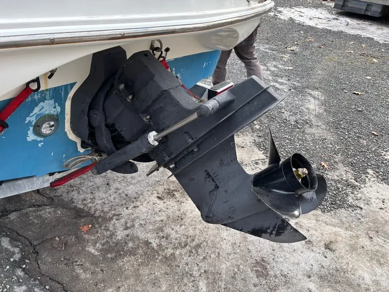 Slide: The Image of Outboard motor of a 2011 Larson 850 boat on gravel surface. - 28