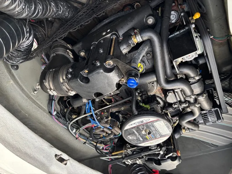 Slide: The Image of Engine compartment of a 2011 Larson 850 boat with complex hoses and wiring. - 5