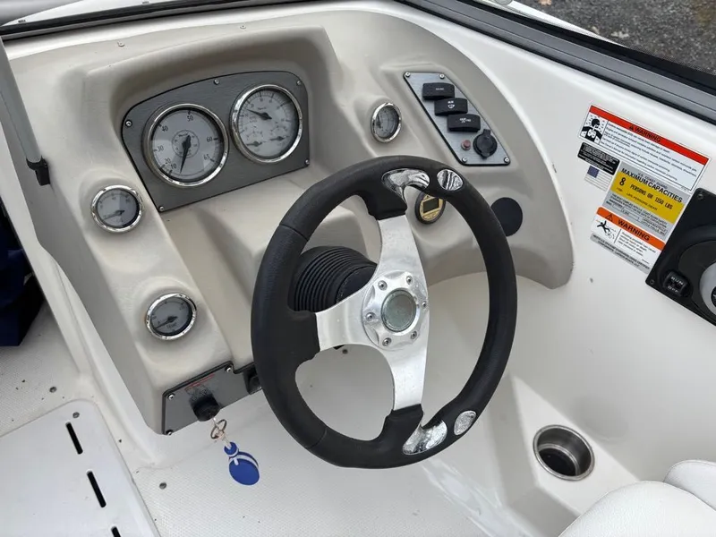Slide: The Image of 2011 Larson 850 boat steering console with gauges. - 8