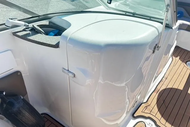 Slide: The Image of 2018 Godfrey Hurricane SD2486 boat interior with white console and wooden deck. - 11