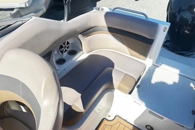 Slide: The Image of Interior seating of a 2018 Godfrey Hurricane SD2486 boat with cup holders and speaker. - 13
