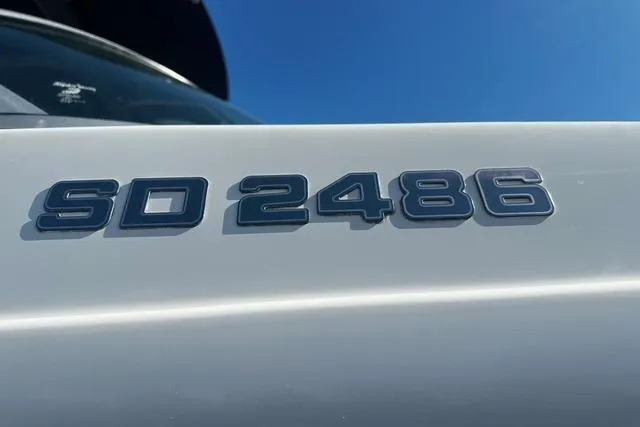 Slide: The Image of 2018 Godfrey Hurricane SD2486 boat model emblem against clear blue sky. - 15