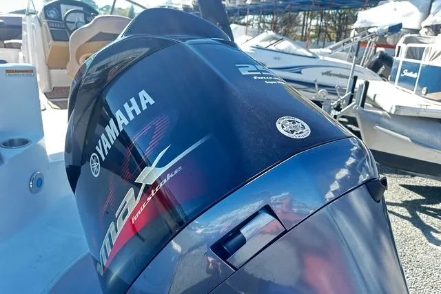 Slide: The Image of 2018 Godfrey Hurricane SD2486 with Yamaha outboard motor in a marina setting. - 16