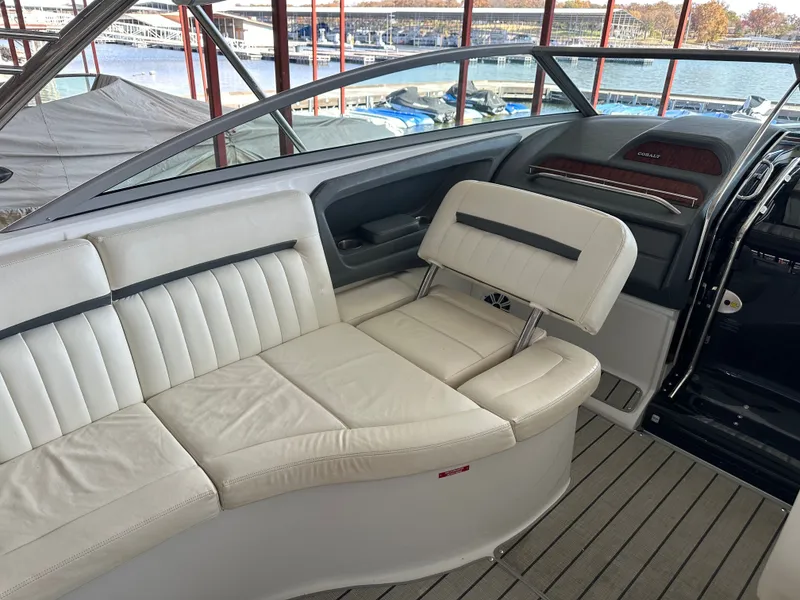 Slide: The Image of Interior of a 2008 Cobalt 323 boat with white leather seating. - 10