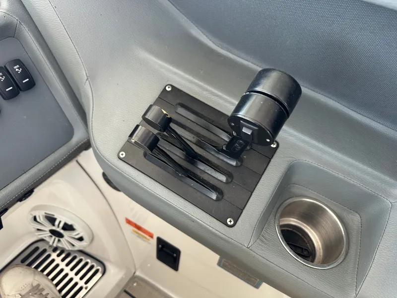 Slide: The Image of Control console of a 2008 Cobalt 323 boat with levers and cup holder. - 32