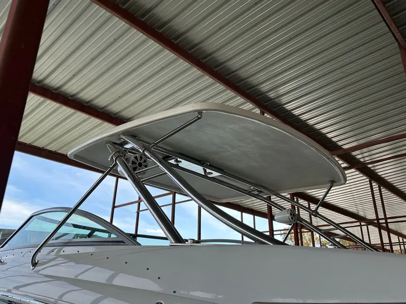 Slide: The Image of 2008 Cobalt 323 boat with canopy under metal roof. - 49