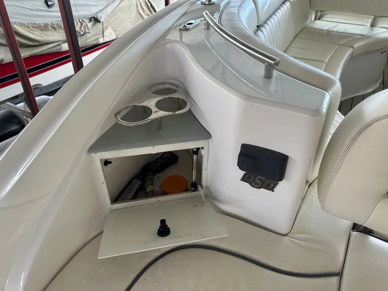 Slide: The Image of Interior of a 2008 Cobalt 323 boat with storage and cup holders. - 6