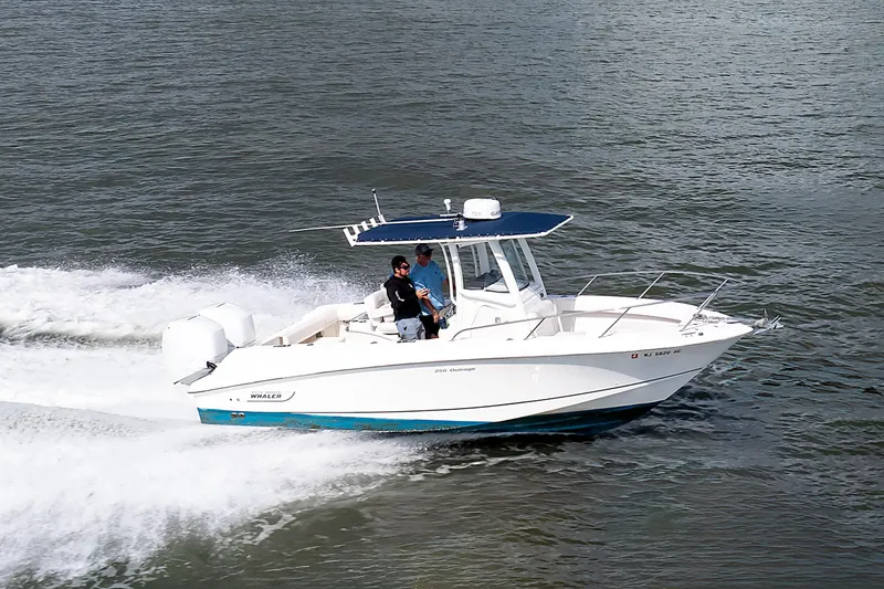 Slide: The Image of 2010 Boston Whaler 250 Outrage cruising on open water, side view. - 2