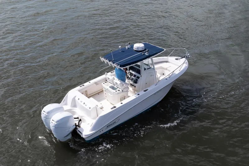 Slide: The Image of 2010 Boston Whaler 250 Outrage boat cruising on open water, featuring twin 225 Mercury Verado engines with 455 hours - 22