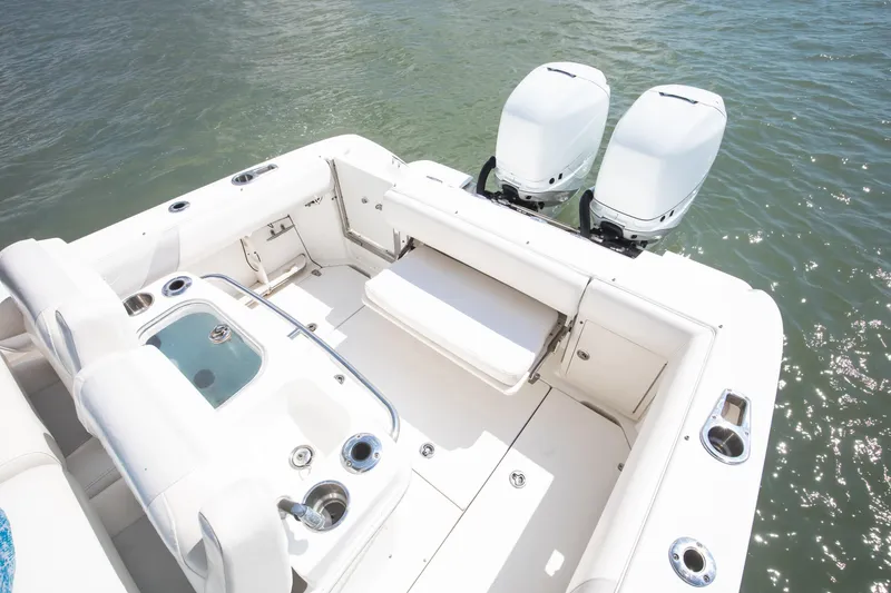 Slide: The Image of 2010 Boston Whaler 250 Outrage boat with twin engines, livewell, tackle center and aft seating. - 28