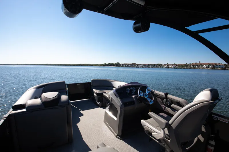 Slide: The Image of 2021 Avalon LSZ Quad Lounger boat interior on a sunny lake. - 29