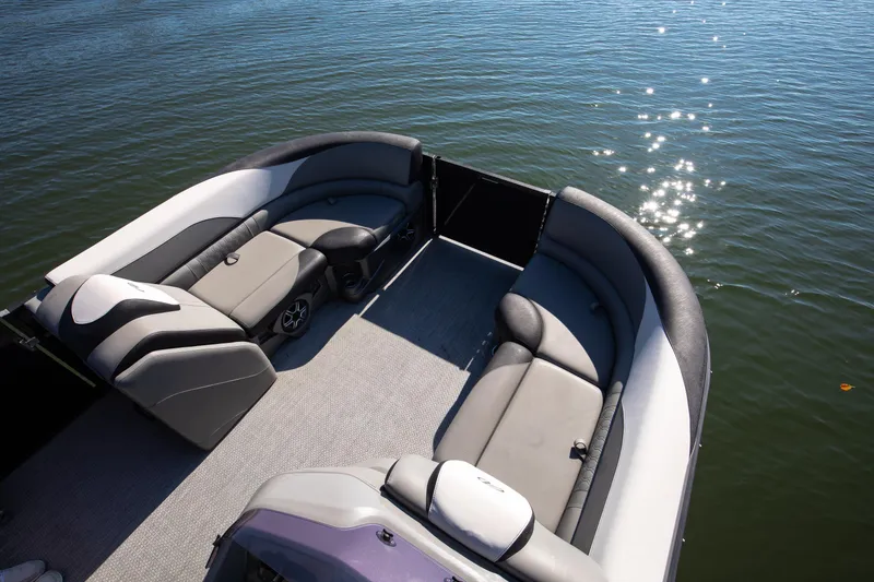 Slide: The Image of 2021 Avalon LSZ Quad Lounger boat interior with plush seating on calm water. - 32