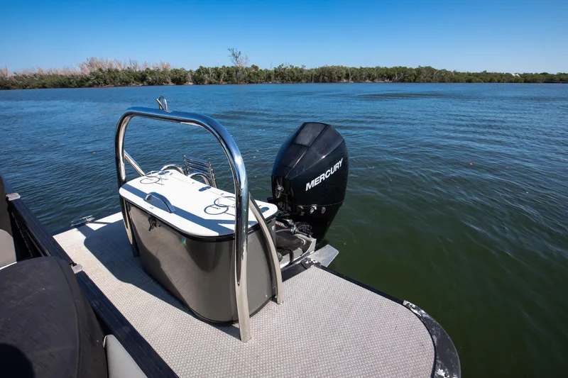 Slide: The Image of 2021 Avalon LSZ Quad Lounger boat with Mercury engine on a serene lake. - 35