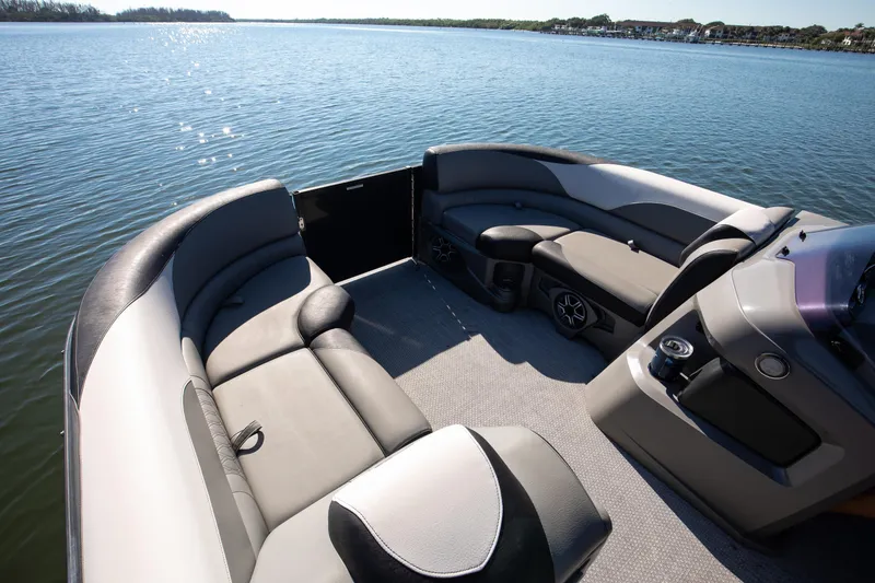 Slide: The Image of 2021 Avalon LSZ Quad Lounger boat interior with comfortable seating on a serene lake. - 38