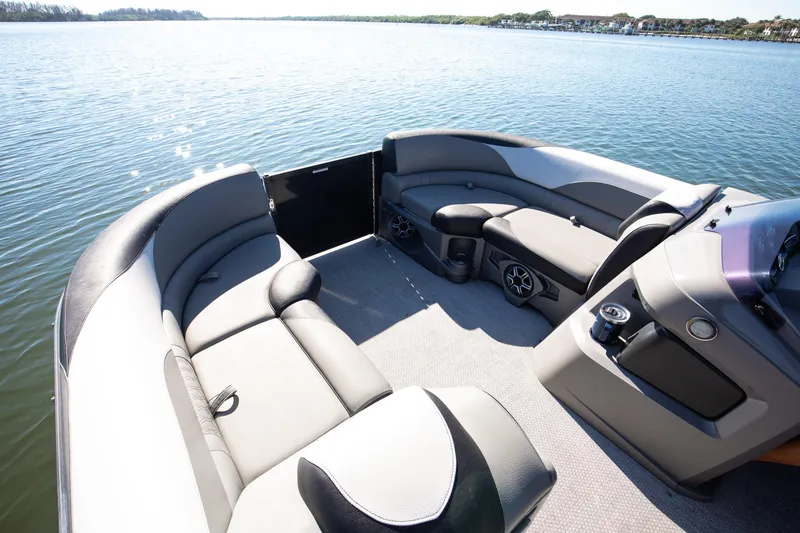 Slide: The Image of 2021 Avalon LSZ Quad Lounger boat interior with spacious seating on a serene lake. - 39