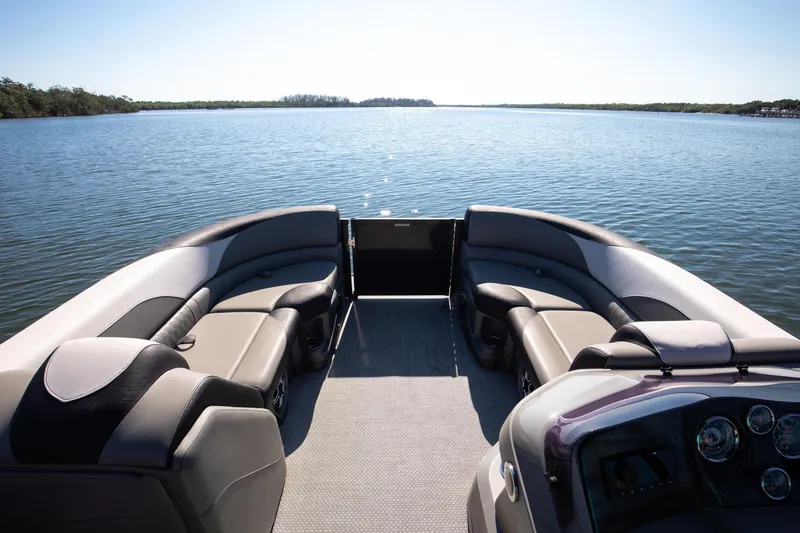 Slide: The Image of 2021 Avalon LSZ Quad Lounger boat interior with lake view, featuring comfortable seating. - 40