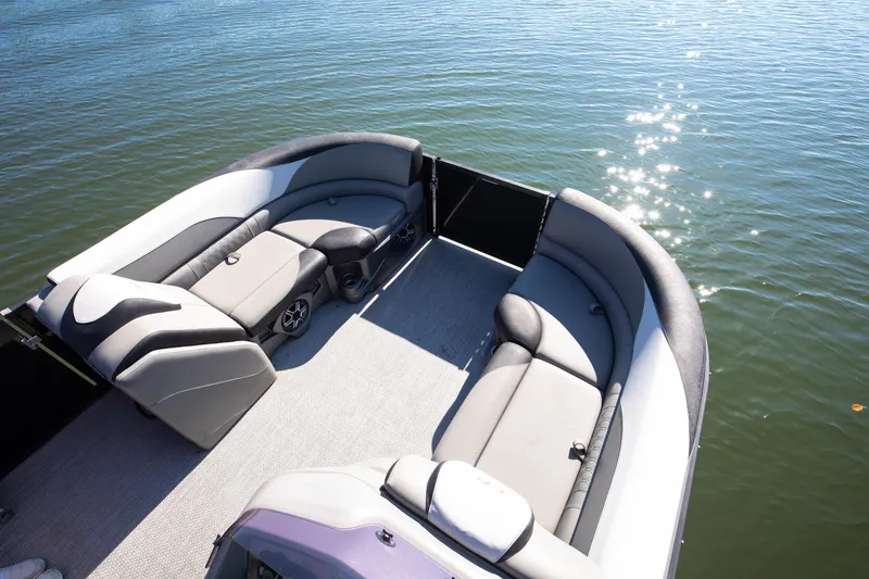 Slide: The Image of 2021 Avalon LSZ Quad Lounger boat interior with plush seating on a sunny day. - 41