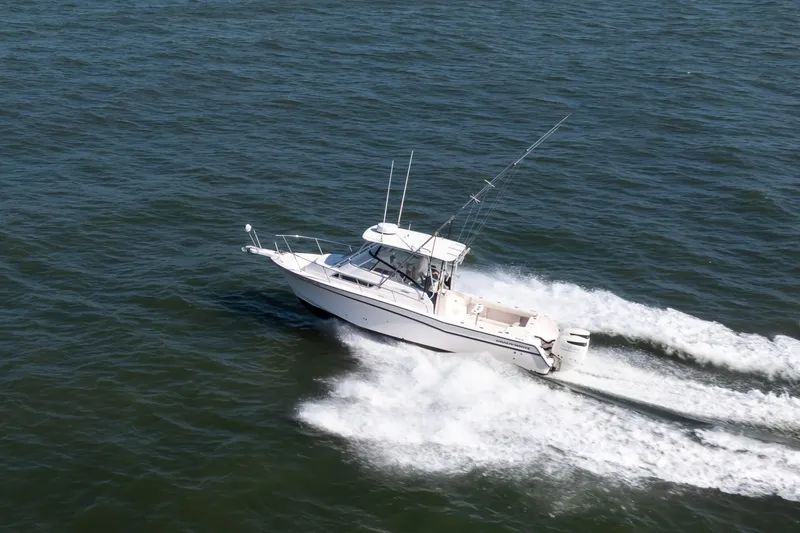 Slide: The Image of 1997 Grady-White Marlin 300 boat cruising on open water. - 11