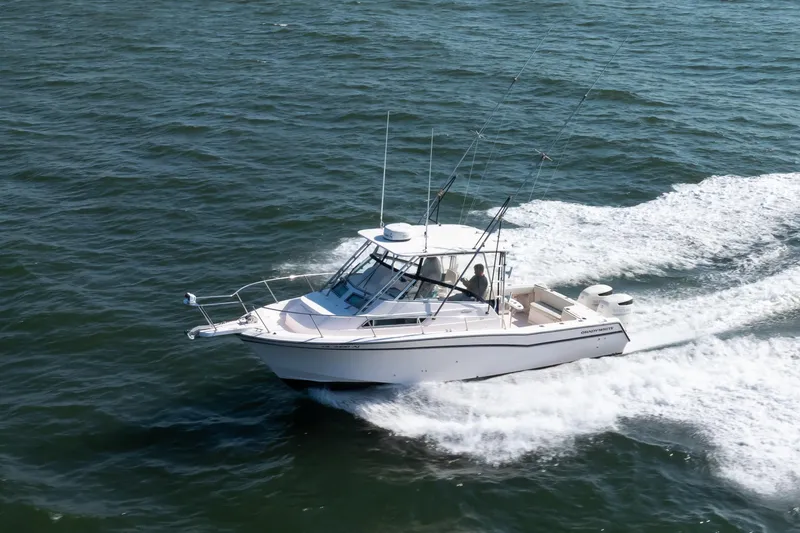 Slide: The Image of 1997 Grady-White Marlin 300 boat cruising on open water. - 15