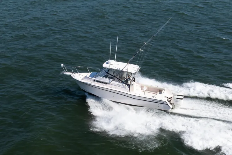 Slide: The Image of 1997 Grady-White Marlin 300 boat cruising on open water. - 17