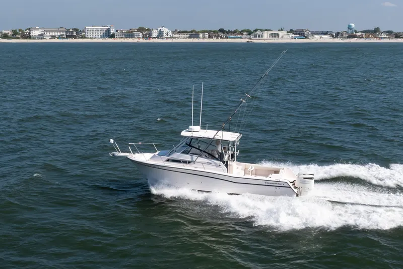 Slide: The Image of 1997 Grady-White Marlin 300 cruising on ocean near coastline. - 18