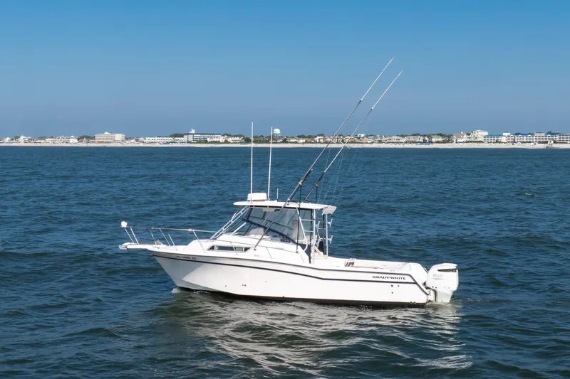 Slide: The Image of 1997 Grady-White Marlin 300 boat on ocean near coastline. - 25