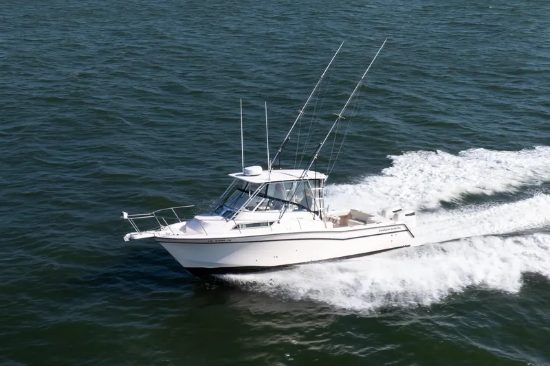 Slide: The Image of 1997 Grady-White Marlin 300 boat cruising on open water. - 3