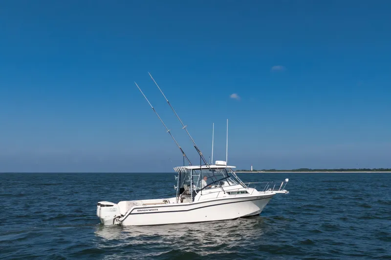Slide: The Image of 1997 Grady-White Marlin 300 boat on open sea under clear blue sky. - 34