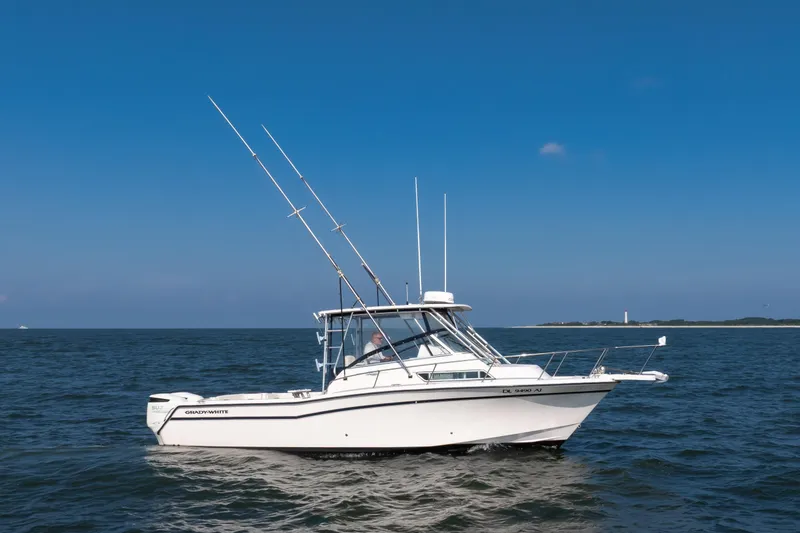 Slide: The Image of 1997 Grady-White Marlin 300 boat on open water under clear blue sky. - 39