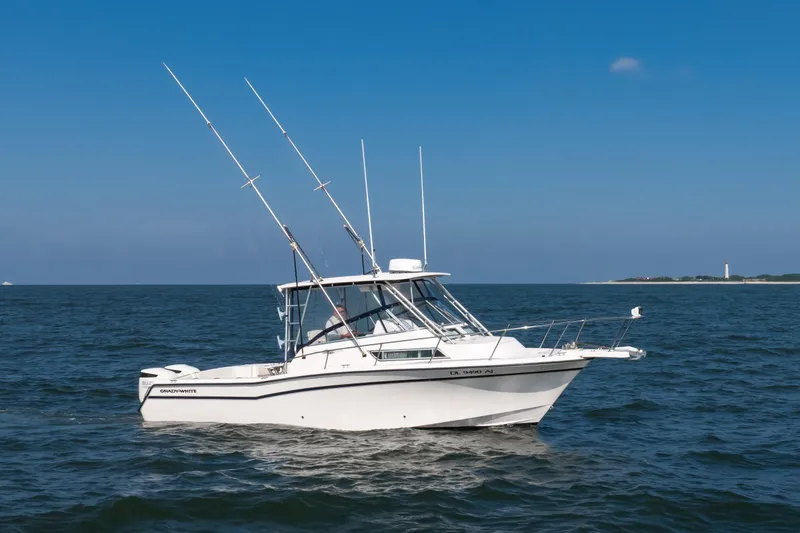 Slide: The Image of 1997 Grady-White Marlin 300 boat on open sea under clear blue sky. - 40