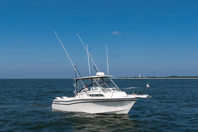 Slide: The Image of 1997 Grady-White Marlin 300 boat on open sea under clear blue sky. - 43