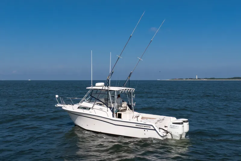 Slide: The Image of 1997 Grady-White Marlin 300 boat on open sea with clear blue sky. - 46