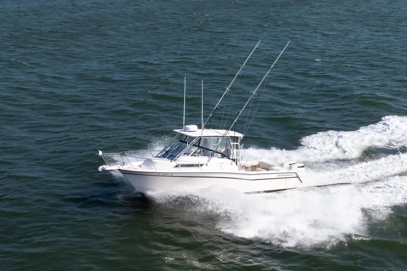 Slide: The Image of 1997 Grady-White Marlin 300 boat cruising on open water. - 5