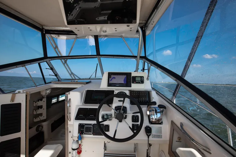 Slide: The Image of Interior view of 1997 Grady-White Marlin 300 boat cockpit with steering wheel and navigation equipment. - 51