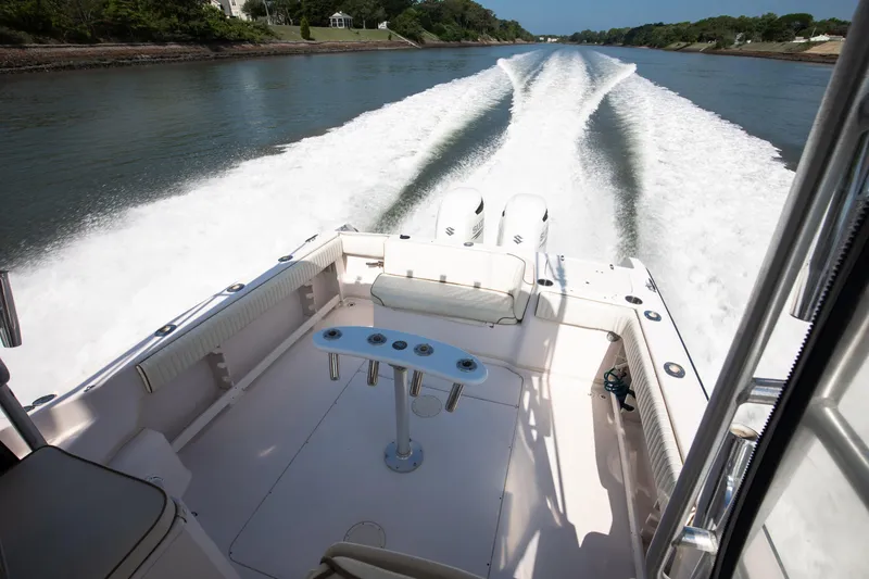 Slide: The Image of 1997 Grady-White Marlin 300 boat cruising on a scenic waterway. - 55