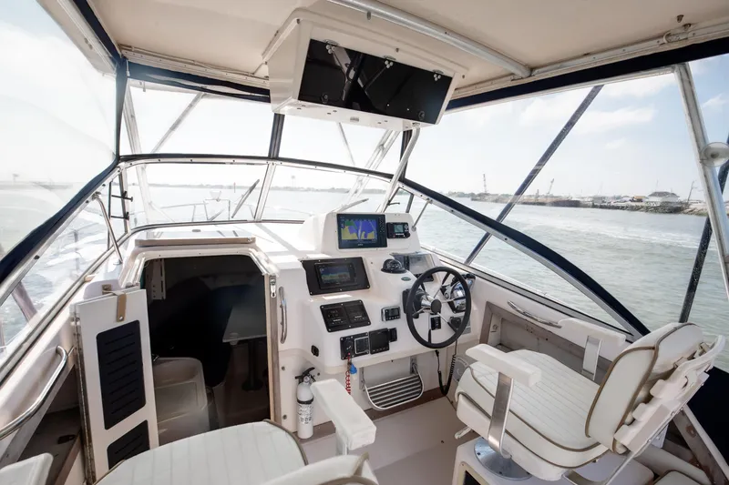 Slide: The Image of Interior view of 1997 Grady-White Marlin 300 boat cockpit with navigation equipment. - 56