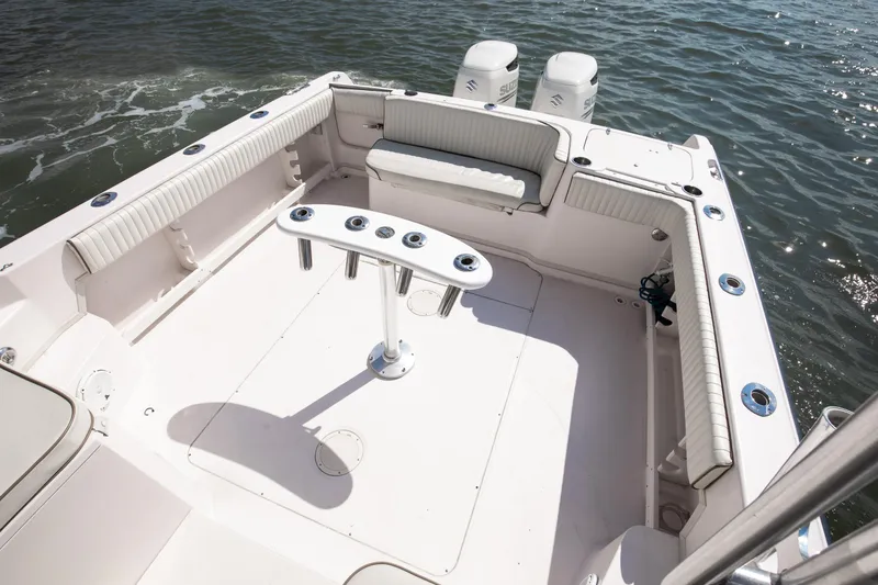 Slide: The Image of 1997 Grady-White Marlin 300 boat deck with seating and rod holders on the water. - 57
