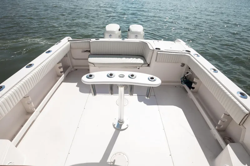 Slide: The Image of 1997 Grady-White Marlin 300 boat deck with seating, ocean view, and fishing rod holders. - 58