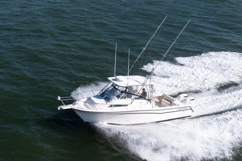 Slide: The Image of 1997 Grady-White Marlin 300 boat cruising on open water. - 6