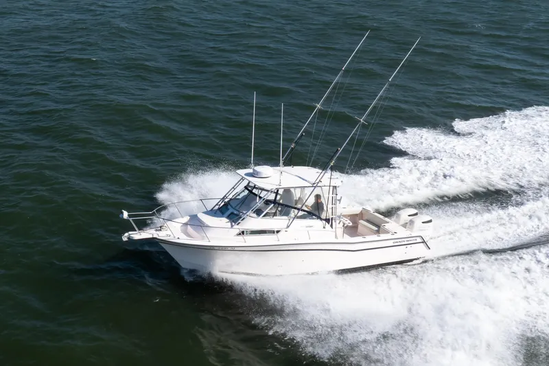 Slide: The Image of 1997 Grady-White Marlin 300 boat cruising swiftly on open water. - 7