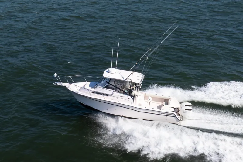 Slide: The Image of 1997 Grady-White Marlin 300 boat cruising on open water. - 8