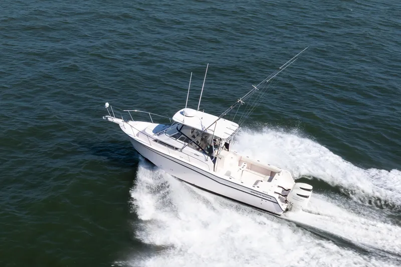 Slide: The Image of 1997 Grady-White Marlin 300 boat cruising on open water. - 9