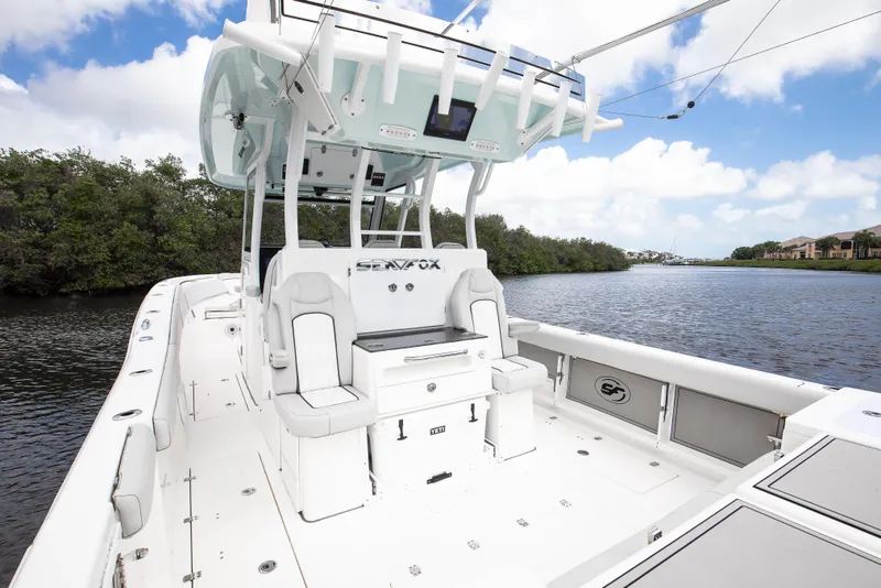 Slide: The Image of 2021 Sea Fox 368 Commander boat on a serene river with lush greenery. - 16