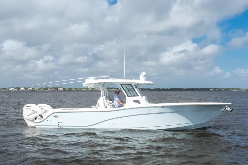 Slide: The Image of 2021 Sea Fox 368 Commander boat cruising on open water under cloudy skies. - 7