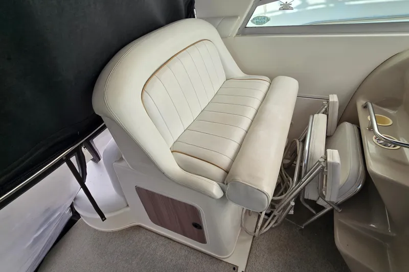 Slide: The Image of 1998 Sea Ray 340 Amberjack interior seating with white upholstery and storage area. - 11