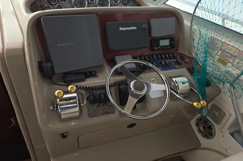 Slide: The Image of 1998 Sea Ray 340 Amberjack helm with Raymarine electronics and steering wheel. - 14