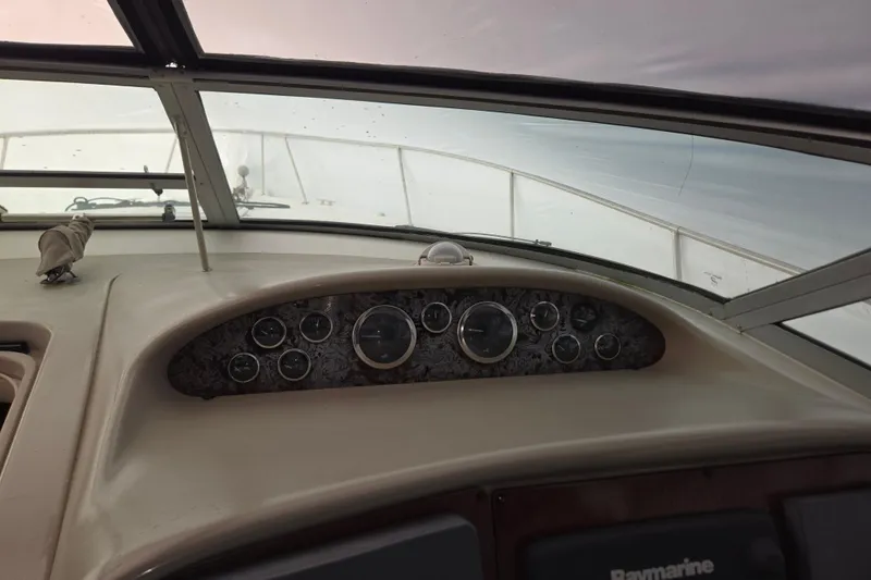 Slide: The Image of 1998 Sea Ray 340 Amberjack dashboard with gauges and navigation equipment. - 17