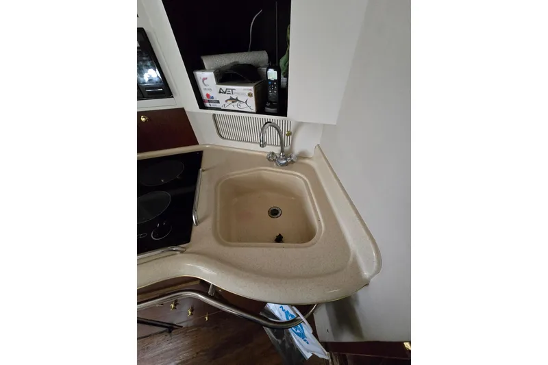 Slide: The Image of 1998 Sea Ray 340 Amberjack kitchen sink and counter area with stove. - 26