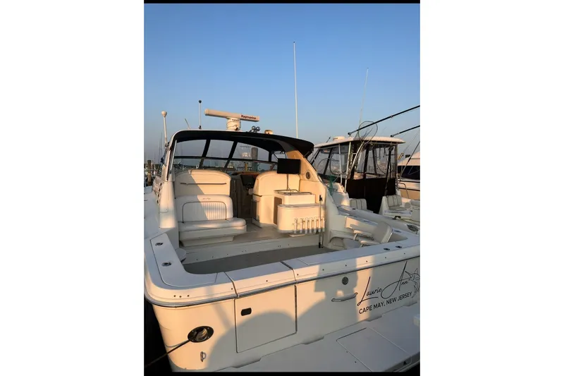 Slide: The Image of 1998 Sea Ray 340 Amberjack boat docked, featuring spacious seating and sleek design. - 3